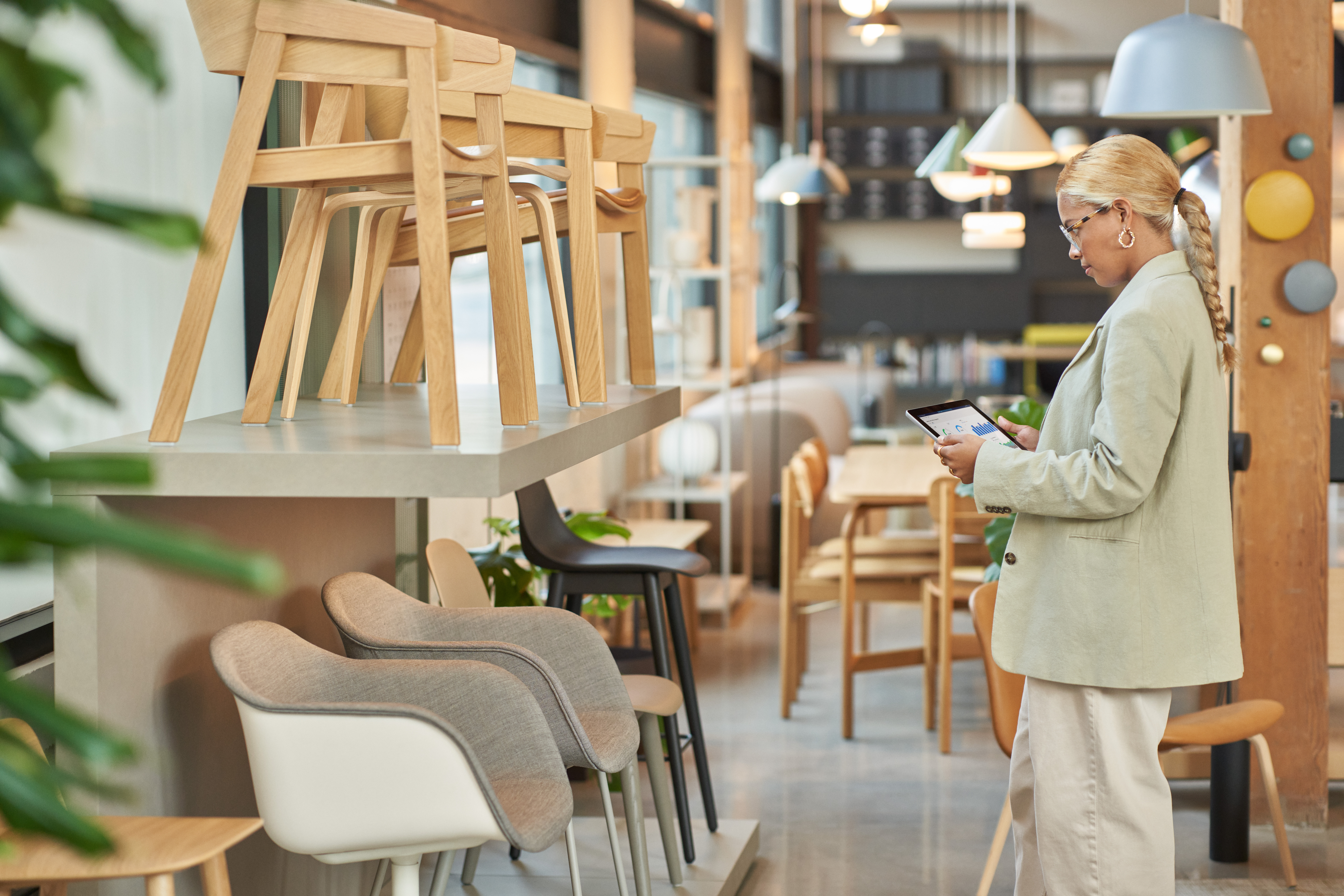 Photo of a female retail store manager using a tablet to review product information