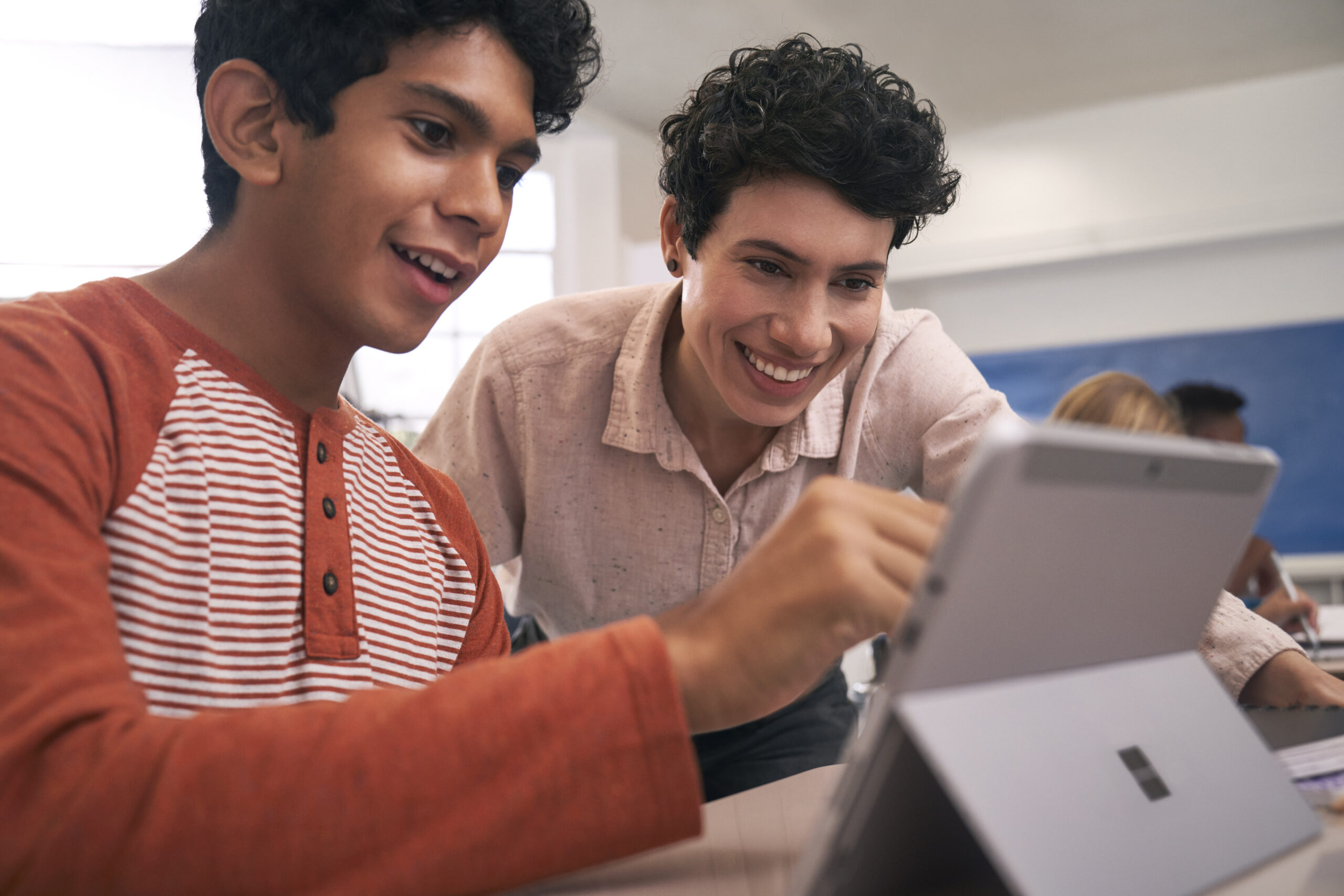 Teacher and student look at AI Agent on a tablet