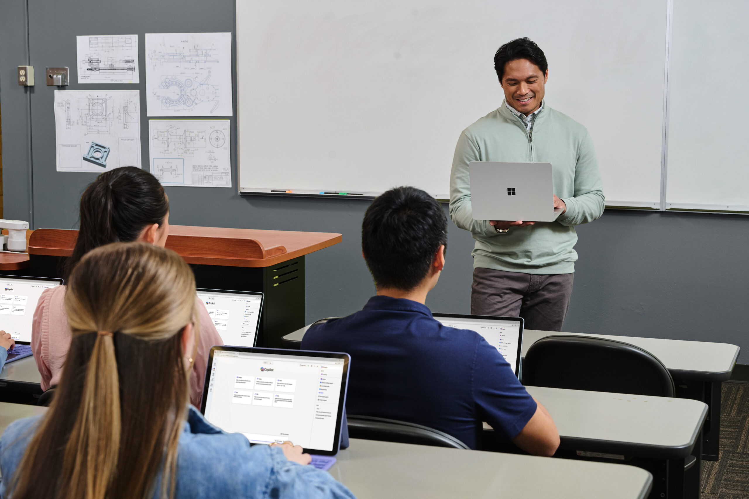 Teacher uses laptop in classroom
