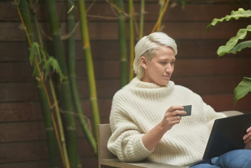 Woman online shopping at home. Connected commerce builds better brand trust.