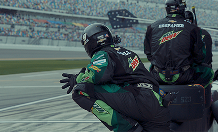 Image of two Hendrick Motorsports team members leaning over a track