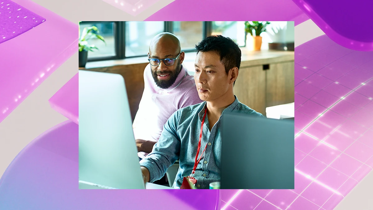 Two people sitting at a desk in an office looking at a computer. Behind the image is a colorful purple graphic design background