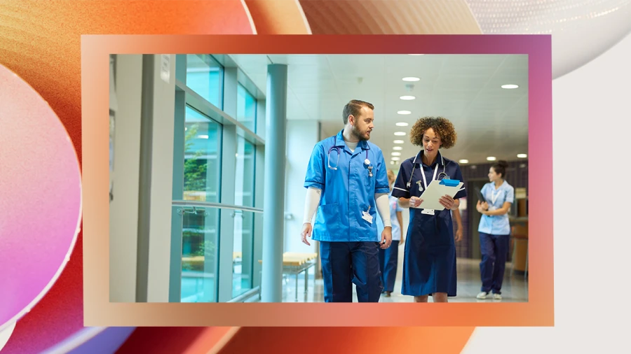Four nurses walking along in a hospital