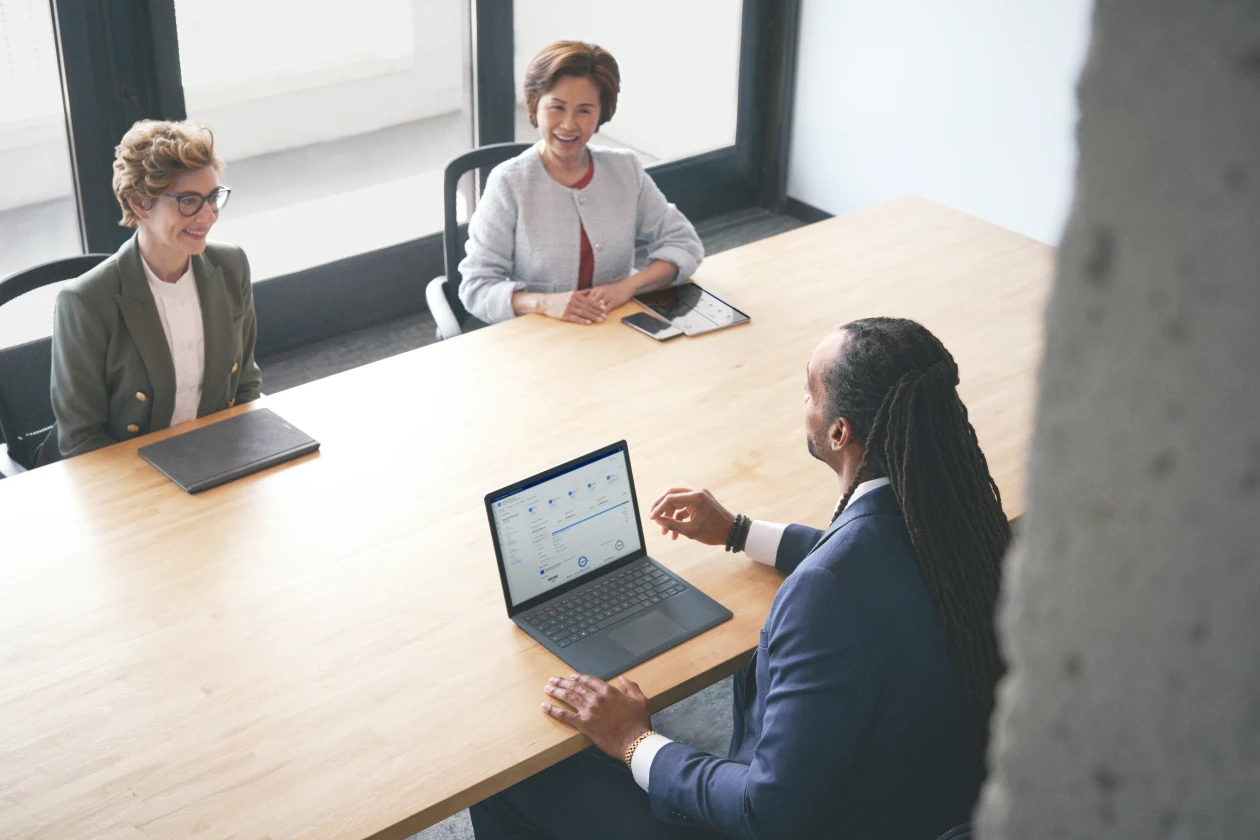 Investment advisor meets with a satisfied customer to assist with investment decisions using intelligent app with real-time data and analytics powered by Azure