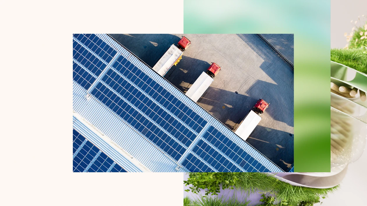 View above three semi trucks parked at a warehouse with solar panels on the roof
