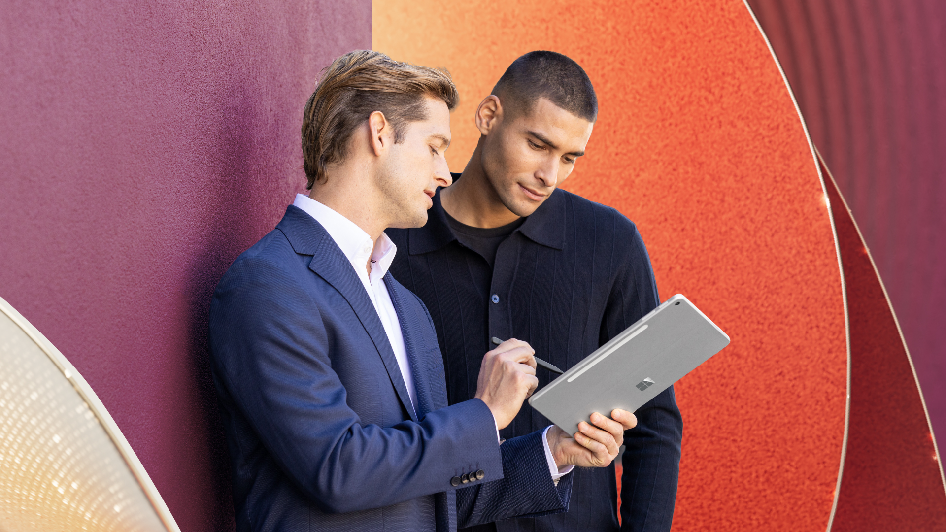 Financial professionals review information on a tablet