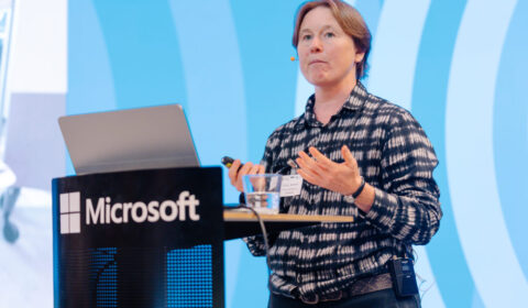 Cecily Morrisson as a podium giving her talk