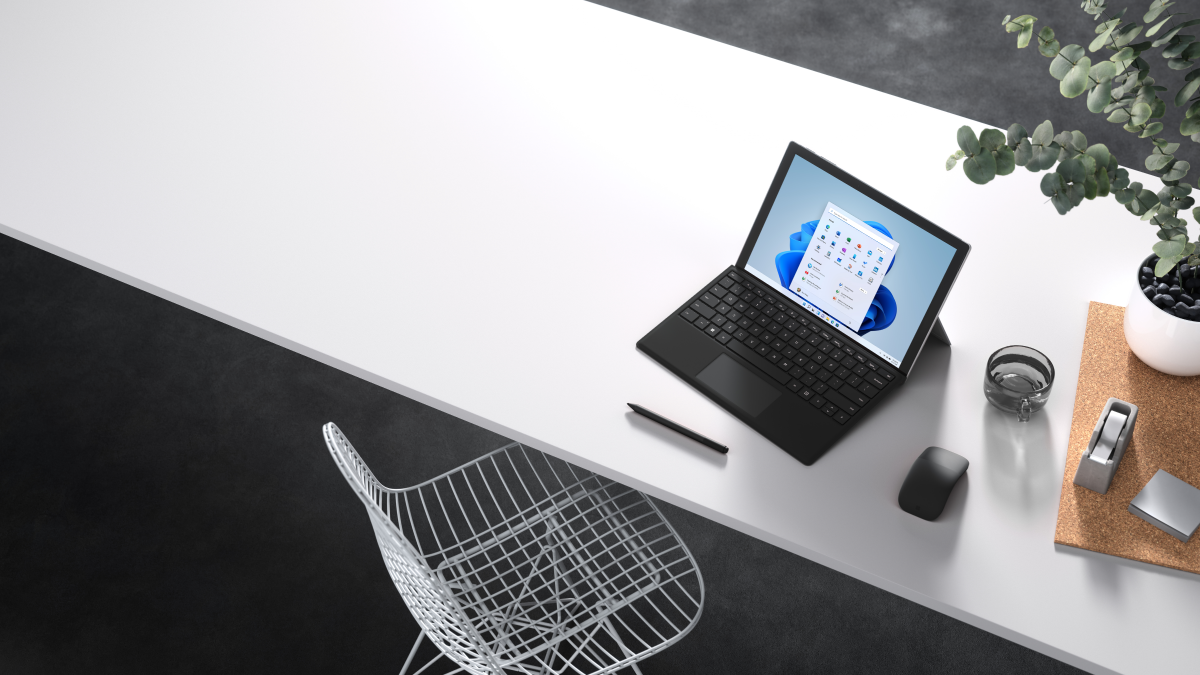 Horizontal format of an attract image of Surface Pro 7+ in laptop mode with black typepad on a desk. Windows 11 screen shown
