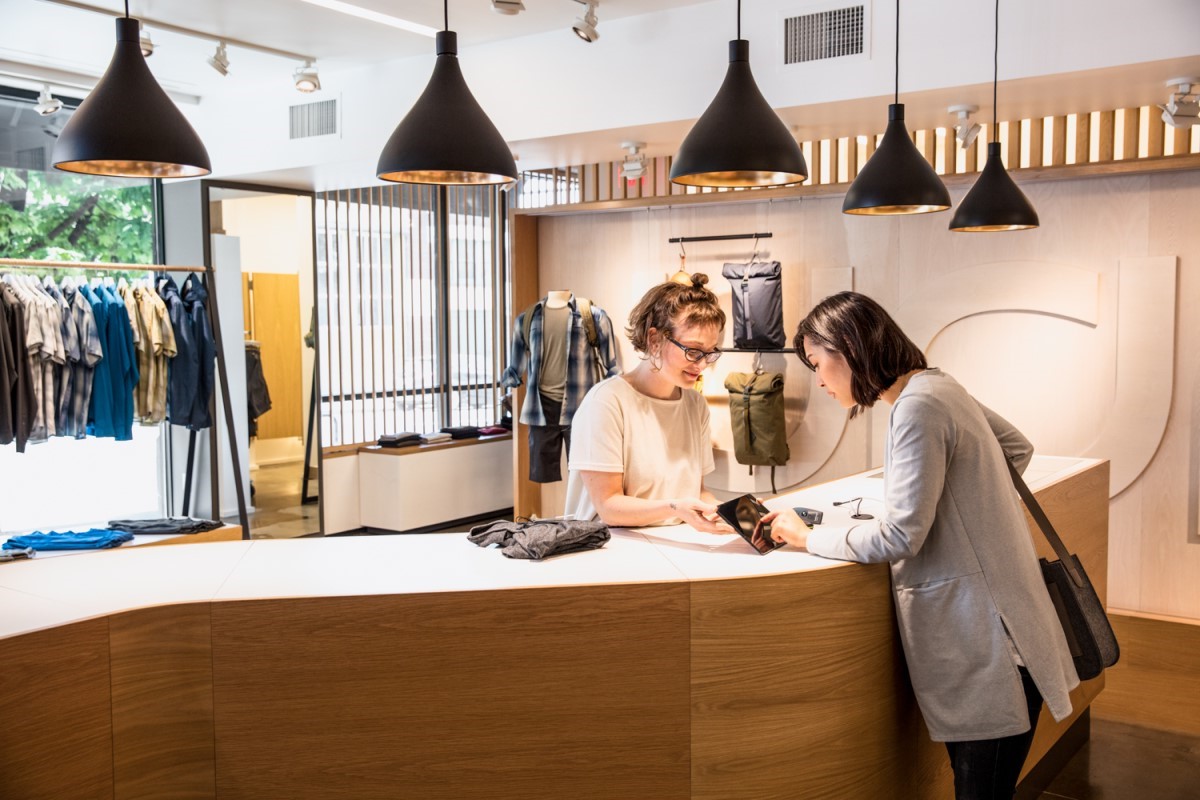 Woman pays for clothing at register