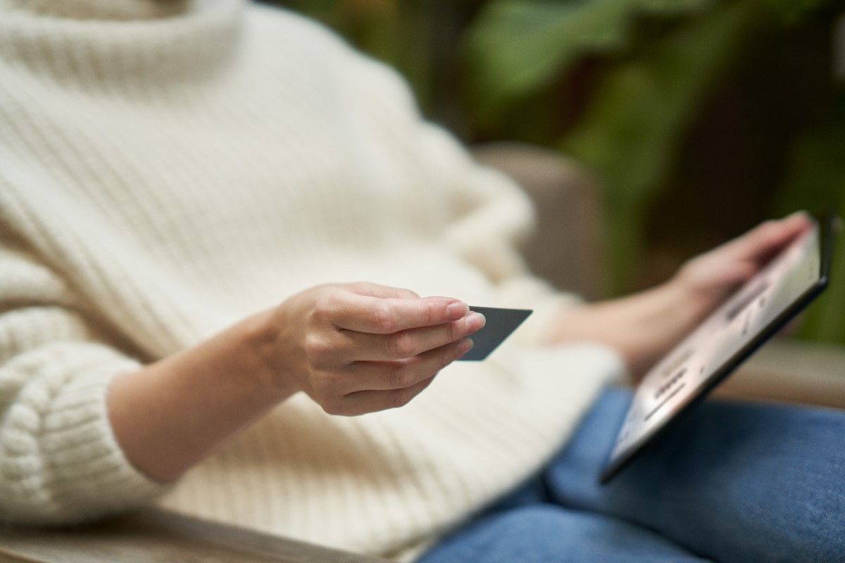 Woman using a credit card to place a secure online order from tablet