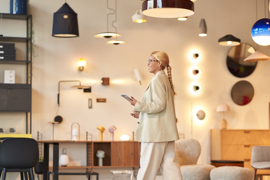 Retail store manager using a tablet while walking the store floor and analyzing data