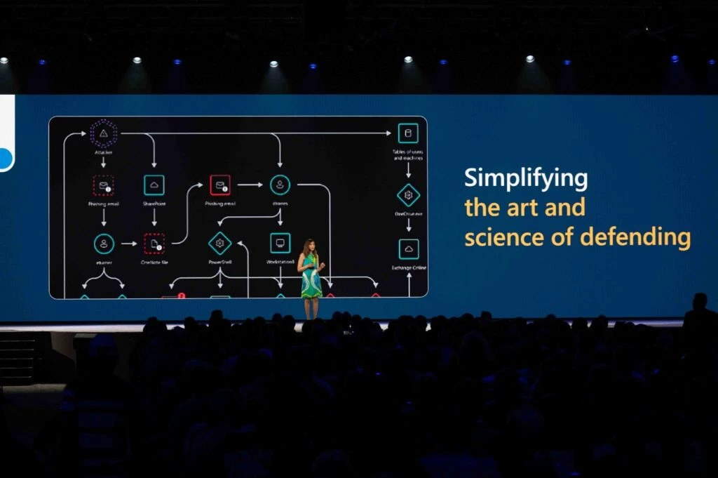Vasu Jakkal presenting in front of a screen that says Simplifying the art and science of defending