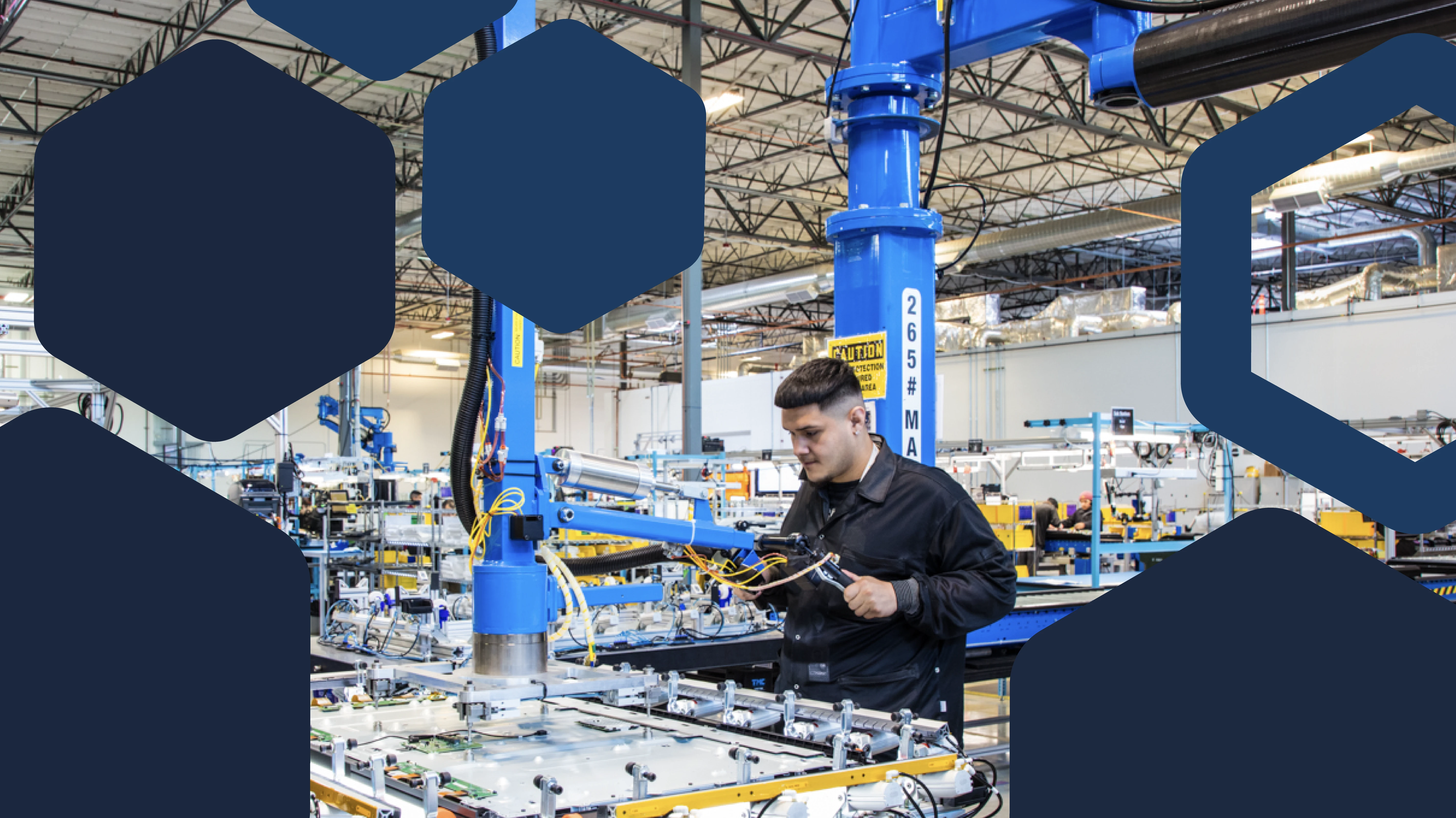 Photo of a worker using industrial tool in electronics factory assembly line