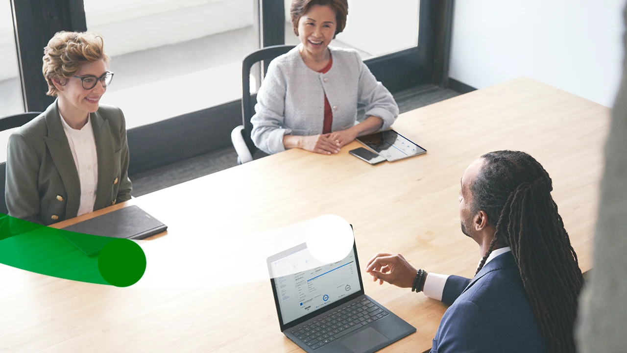 Investment advisor meets with a satisfied customer to assist with investment decisions using intelligent app with real-time data and analytics powered by Azure