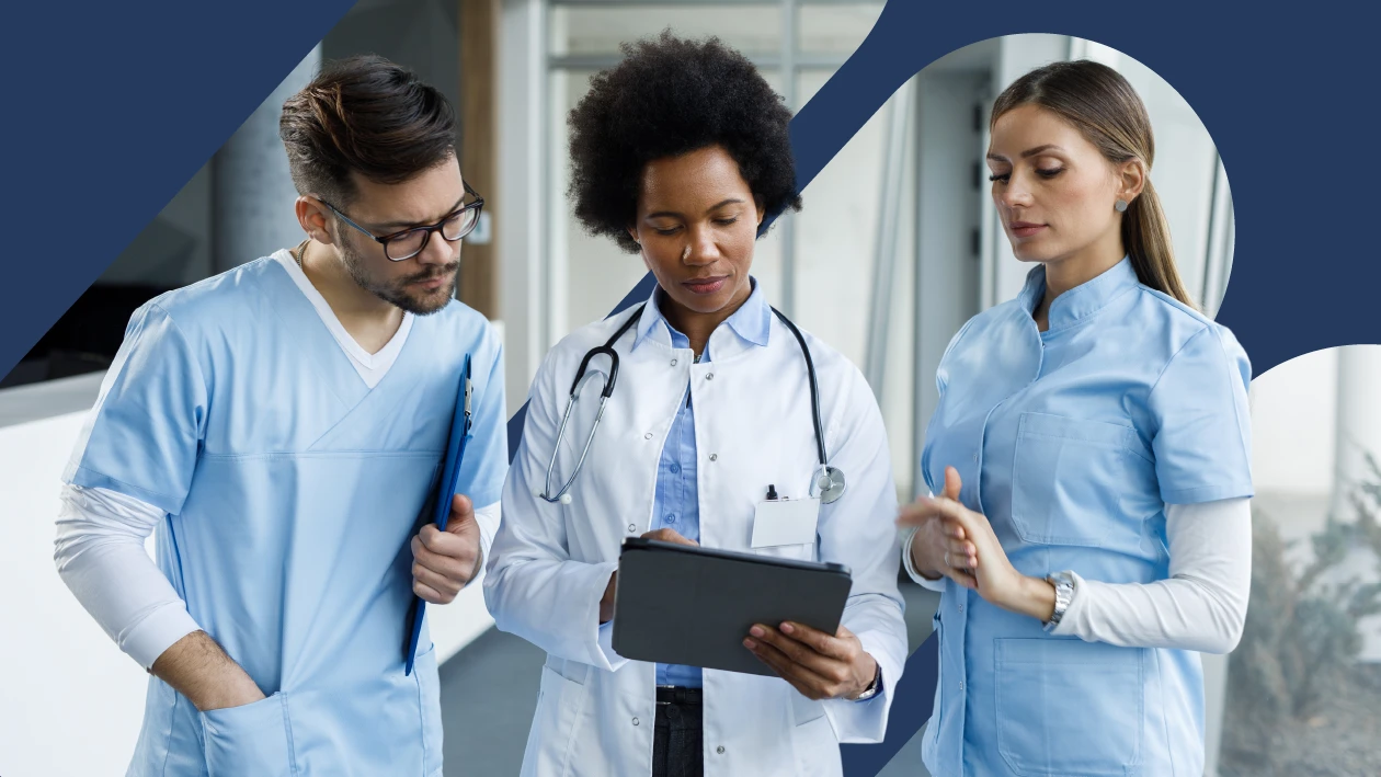 A group of healthcare workers look at a tablet