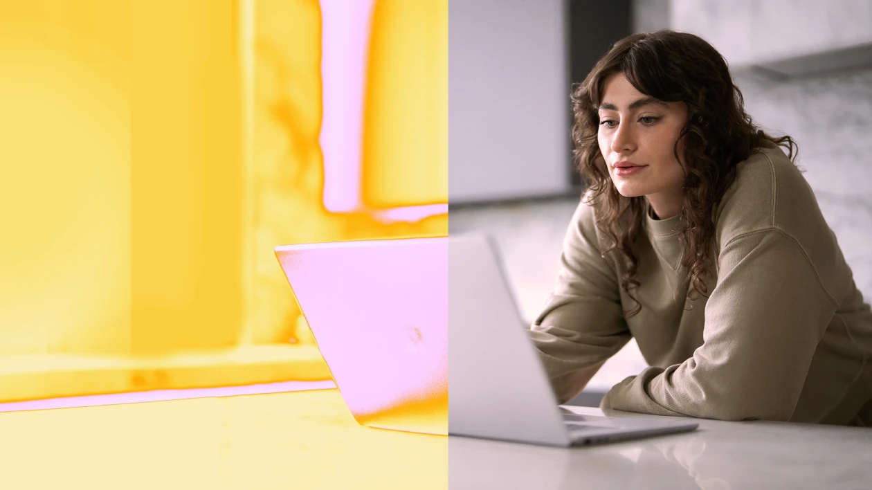 A woman looking at a laptop