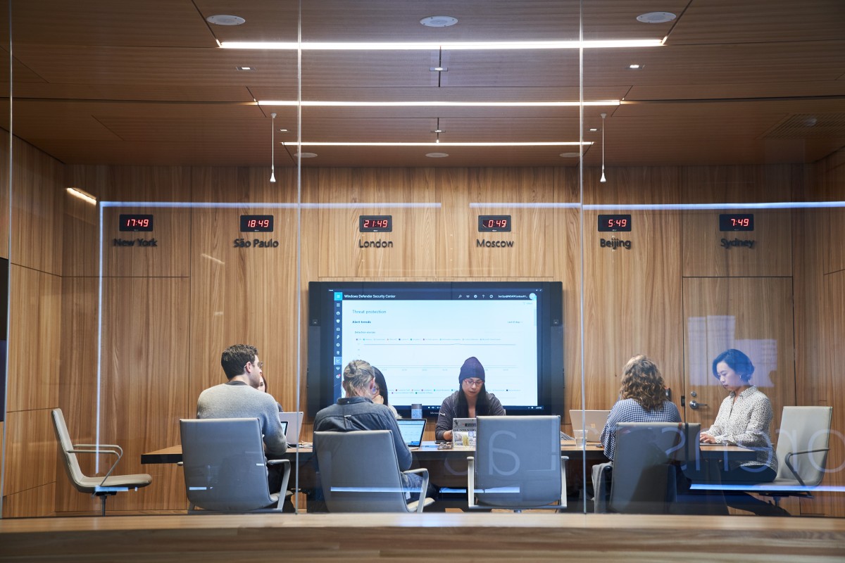 A group of people sitting at a table in a conference room