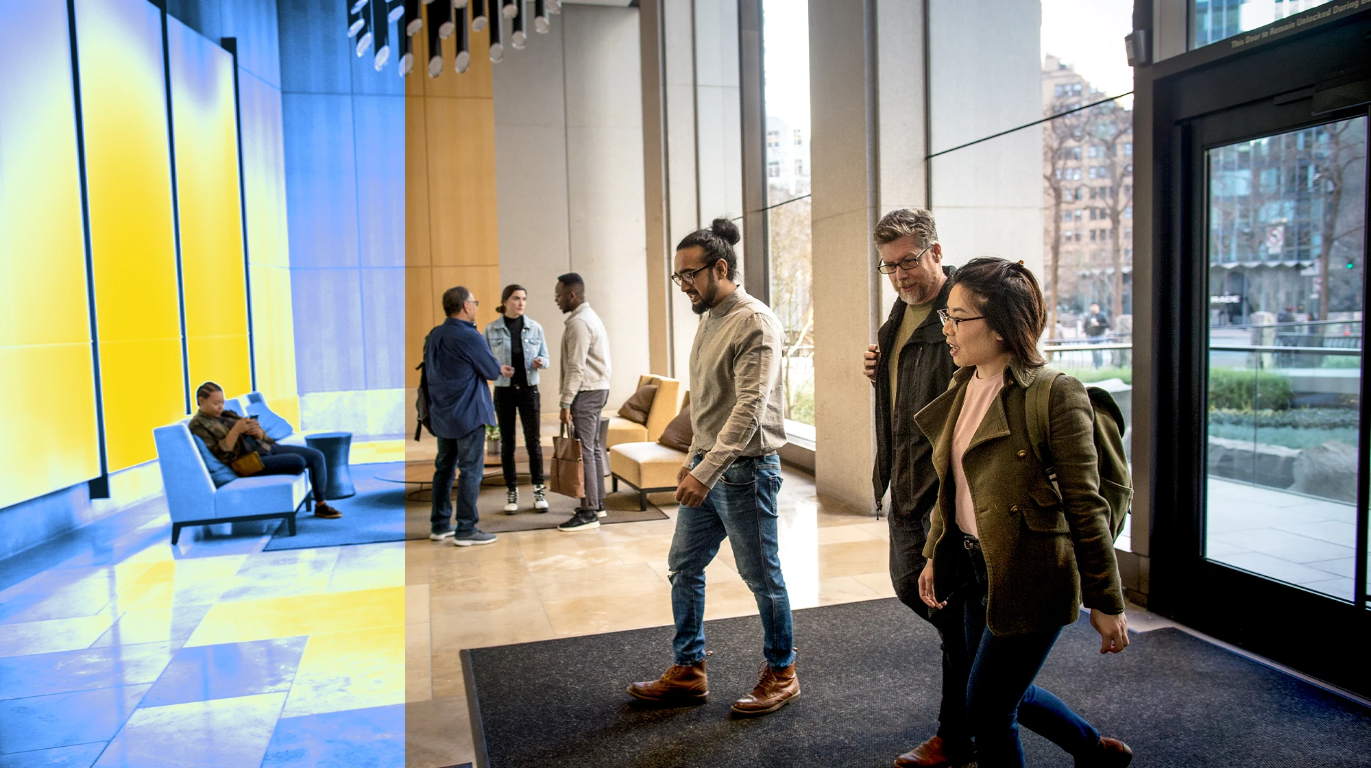 A group of people walking in the lobby of an office building