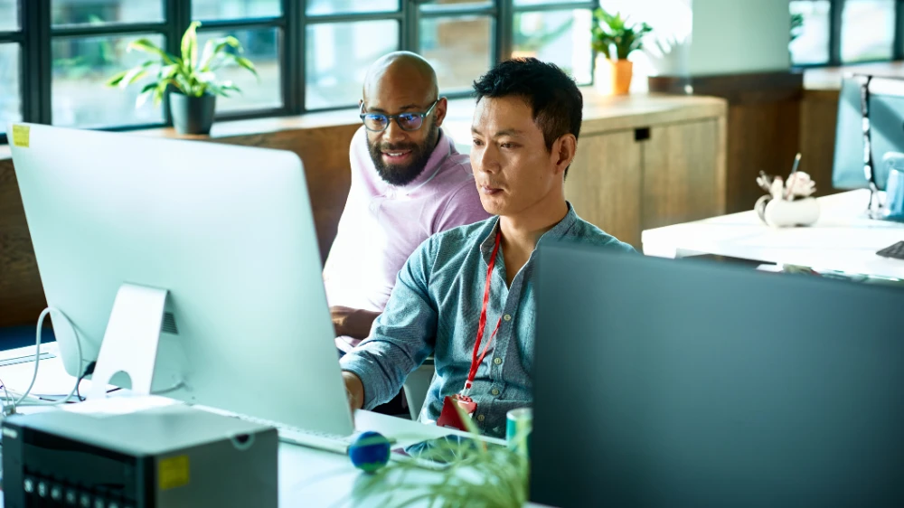 Two colleagues collaborating at a desk