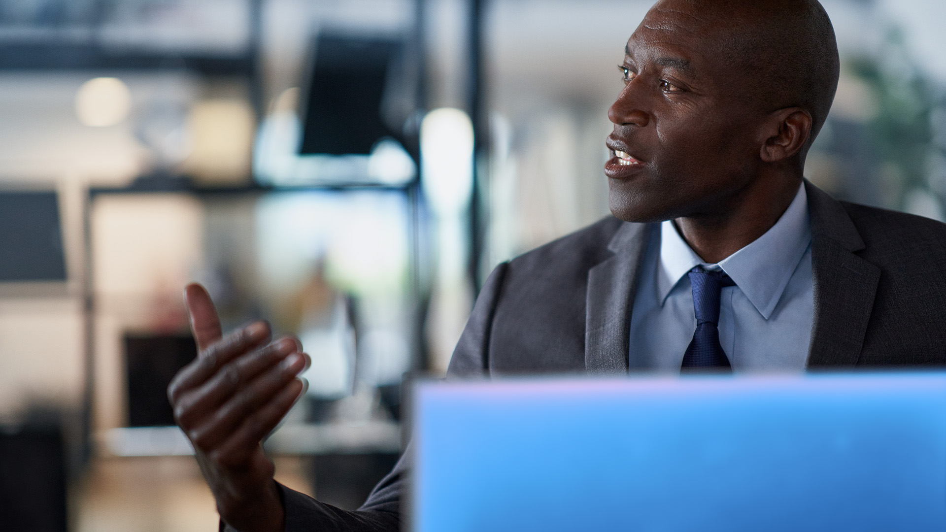 A security executive sits in front of a computer screen