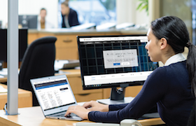 a person sitting at a desk in front of a computer
